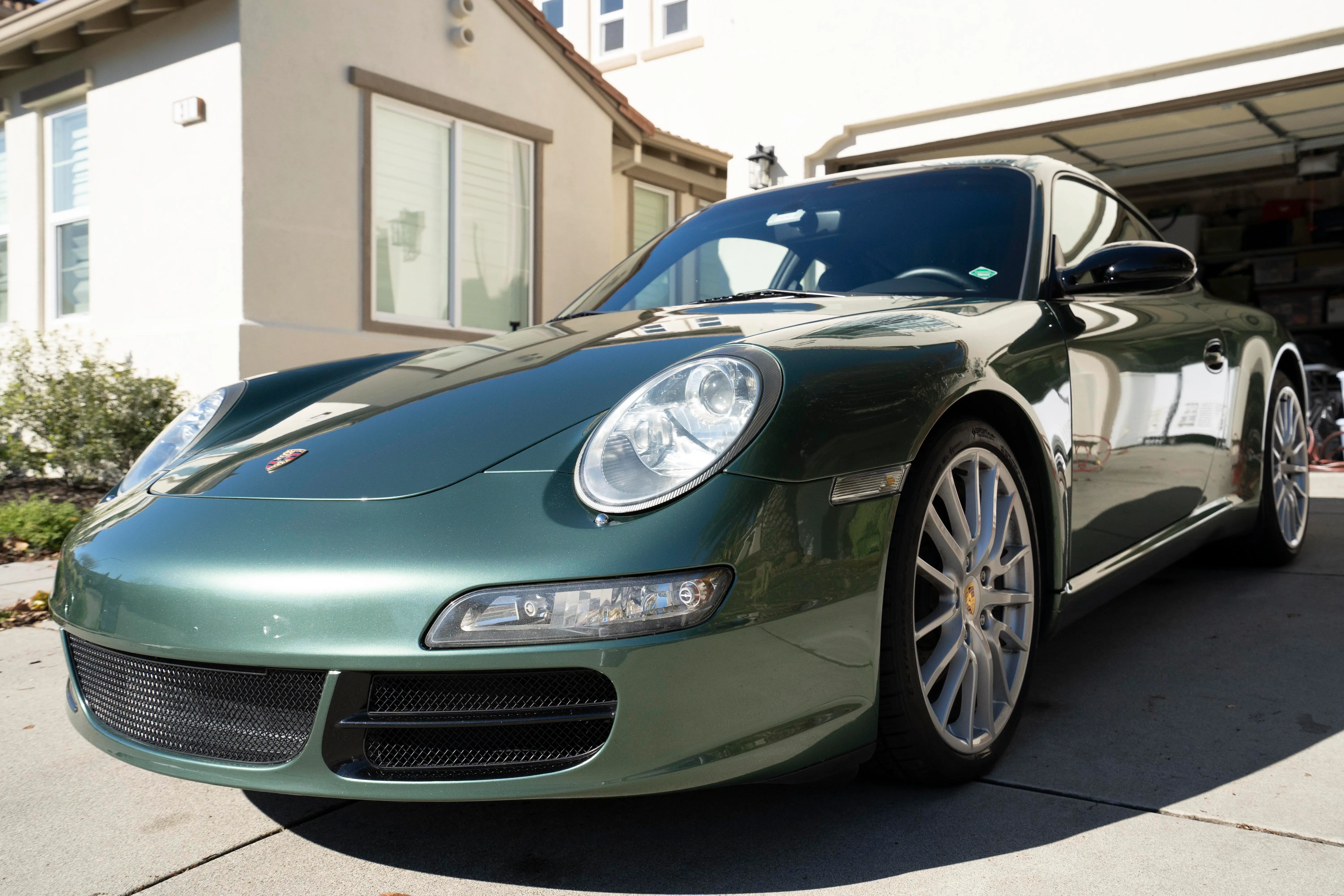 Green Porsche 911 with restored headlights and corrected paint