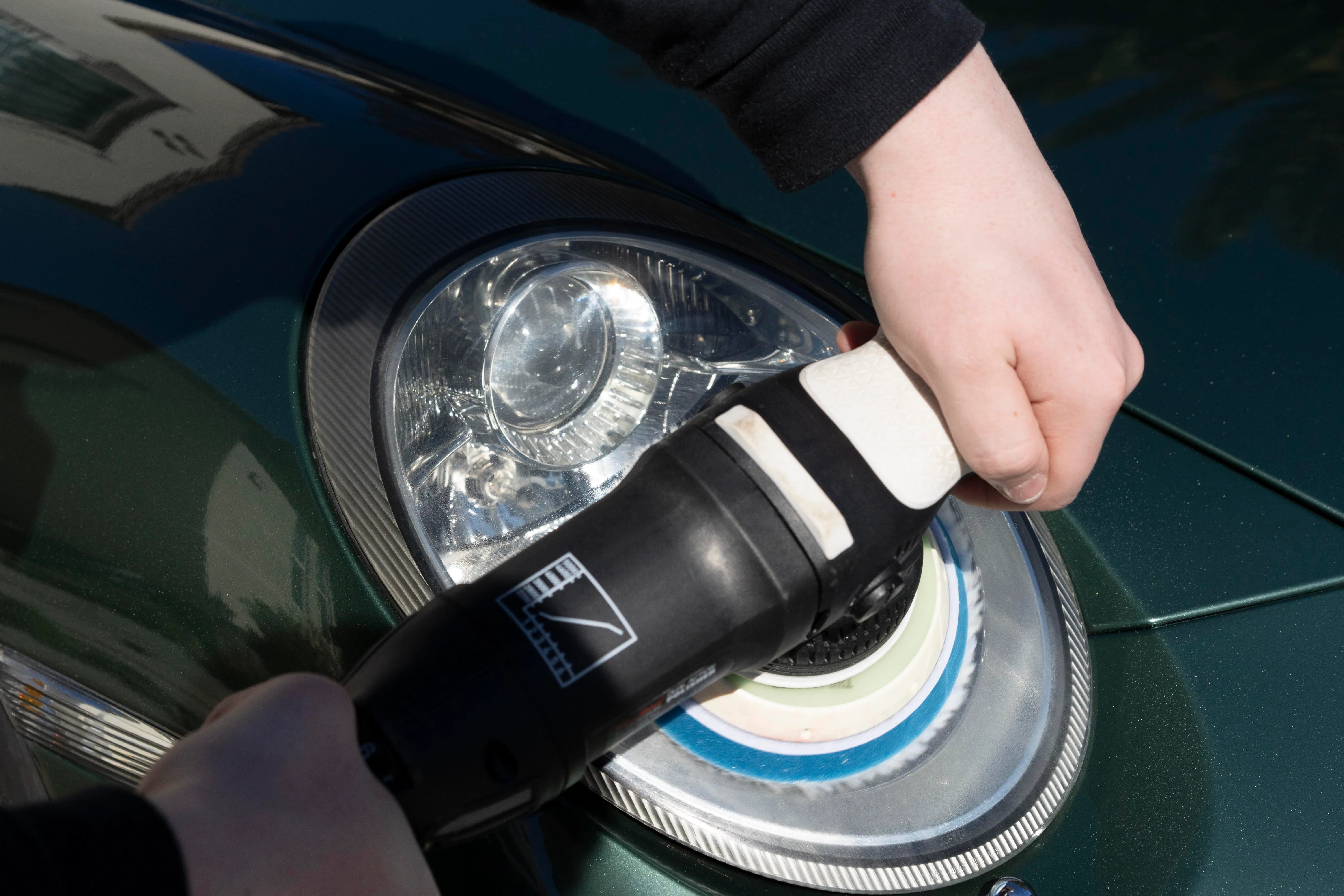 Headlight restoration in progress on a Porsche 911