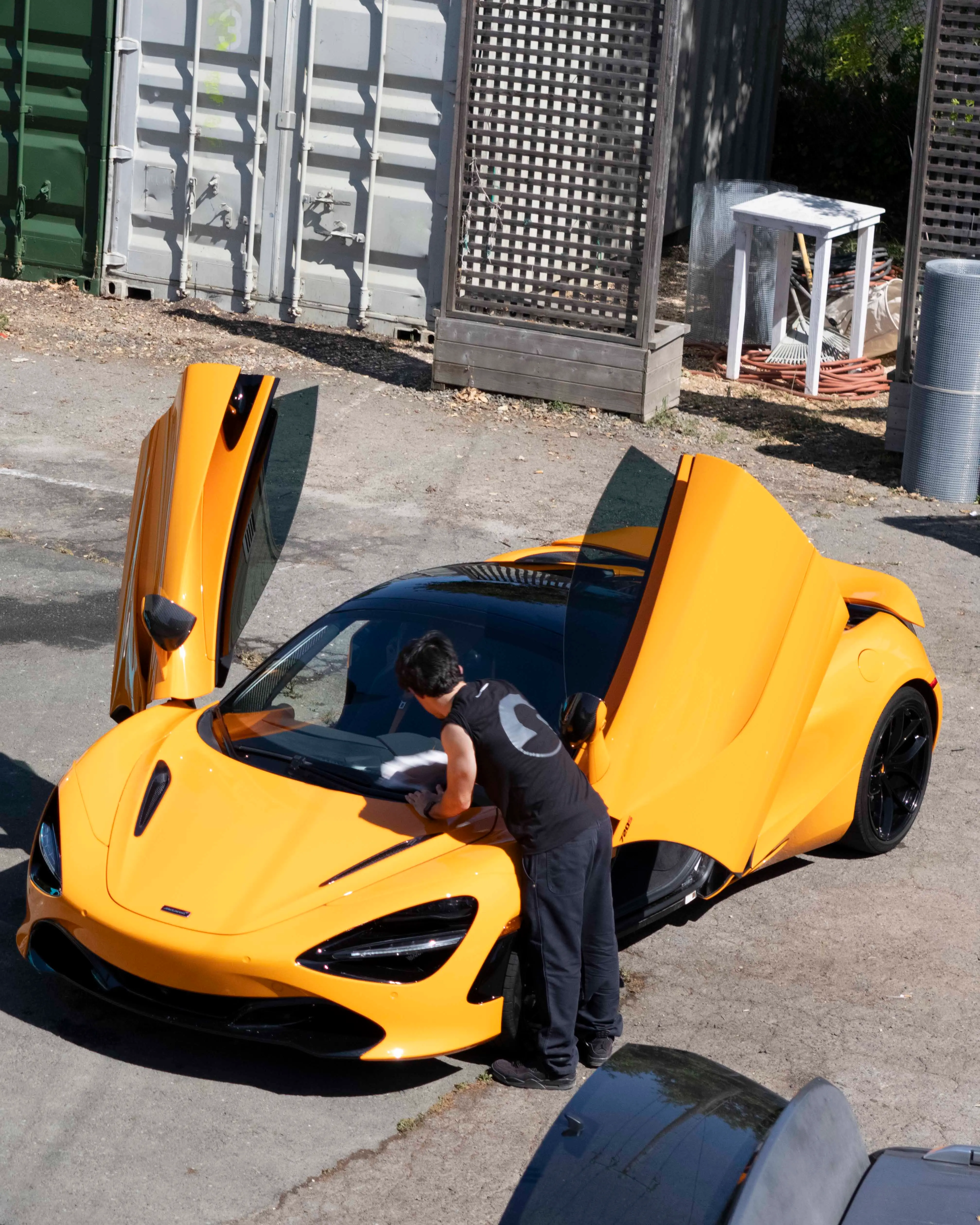Yellow McLaren 720S with doors up during a detail
